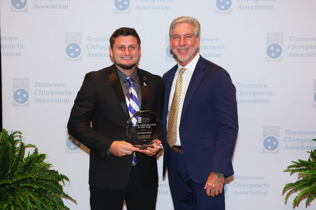 Dr. Palmer Piana holding his 2026 Rising Chiropractor of the Year award beside TCA President Dr. Richard Cole.